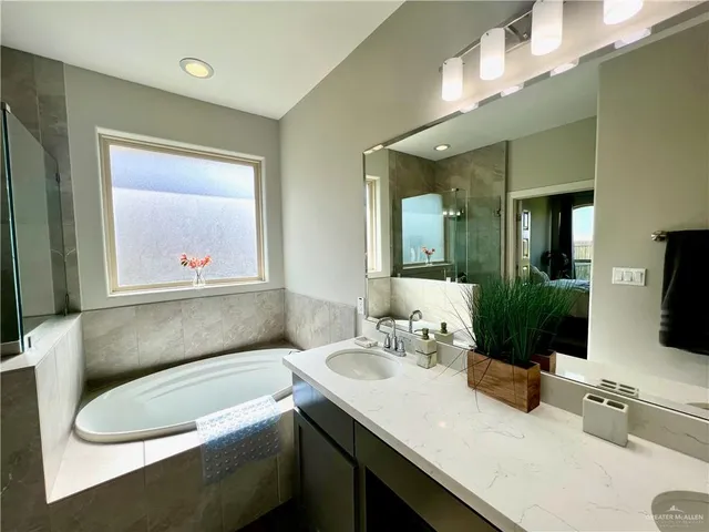 a bathroom with a double vanity sink and a mirror
