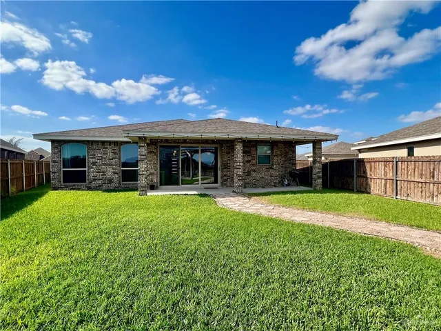 a view of house with yard and outdoor seating