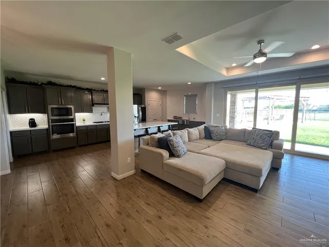 a living room with furniture and kitchen view