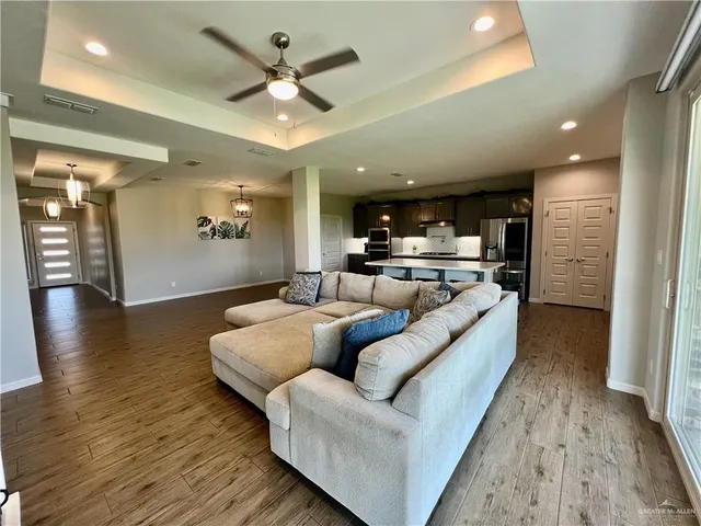 a living room with furniture and kitchen view