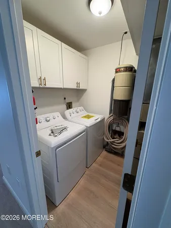 a utility room with sink dryer and washer