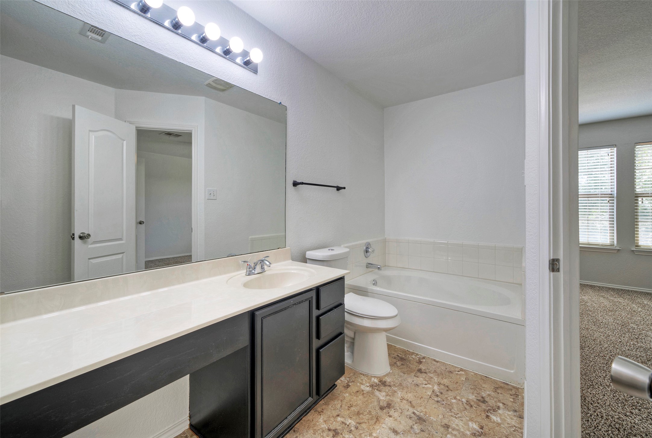 140 Plum Path Kyle, TX 78640 - Photo 9 of 22 a bathroom with a sink a toilet a mirror and bathtub