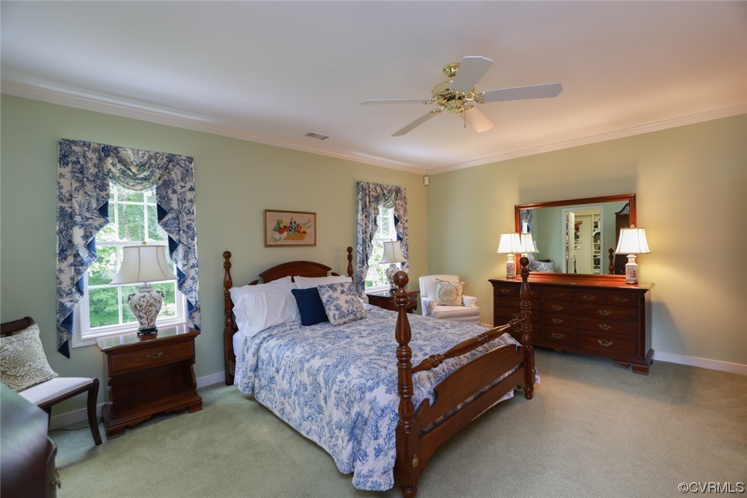 12610 Lilking Road Chester, VA 23831 - Photo 27 of 50 a spacious bedroom with a bed and a chandelier