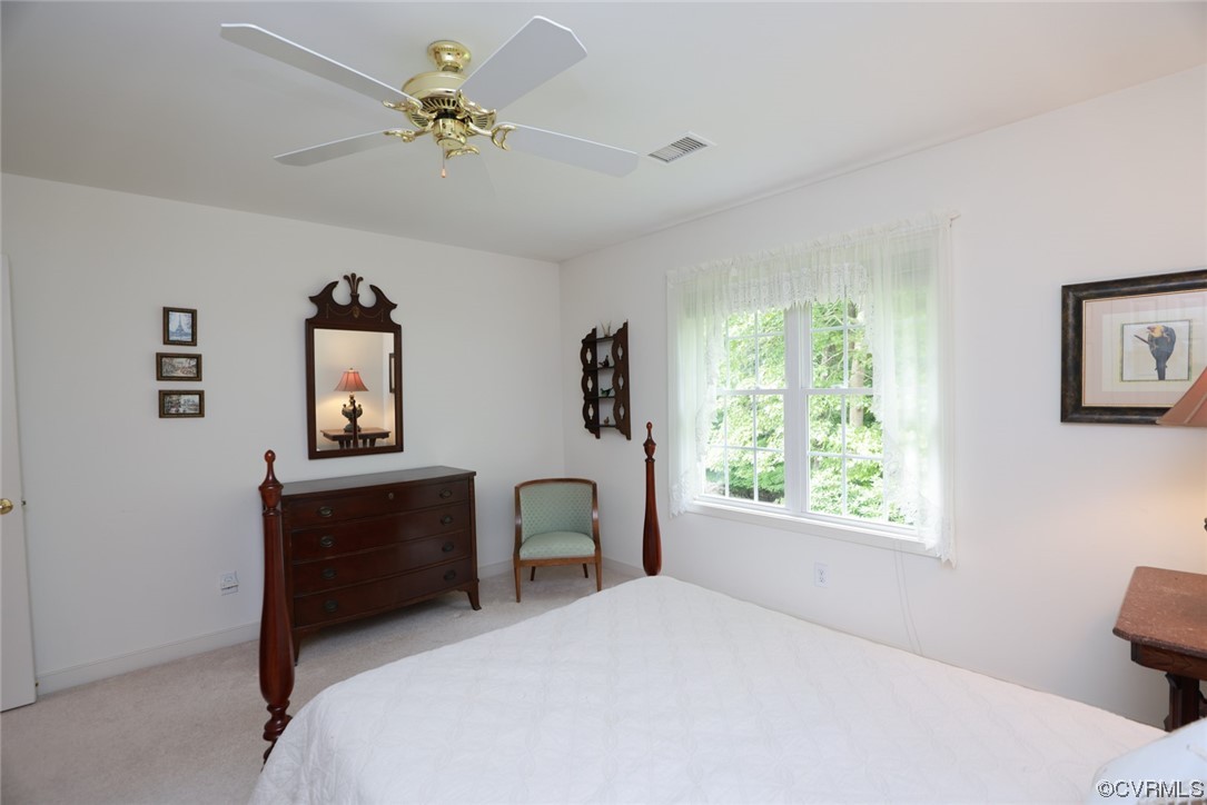 12610 Lilking Road Chester, VA 23831 - Photo 33 of 50 a bedroom with a bed and a chandelier