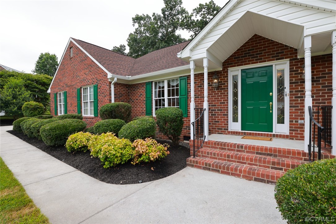 12610 Lilking Road Chester, VA 23831 - Photo 4 of 50 a front view of a house with a yard and potted plants