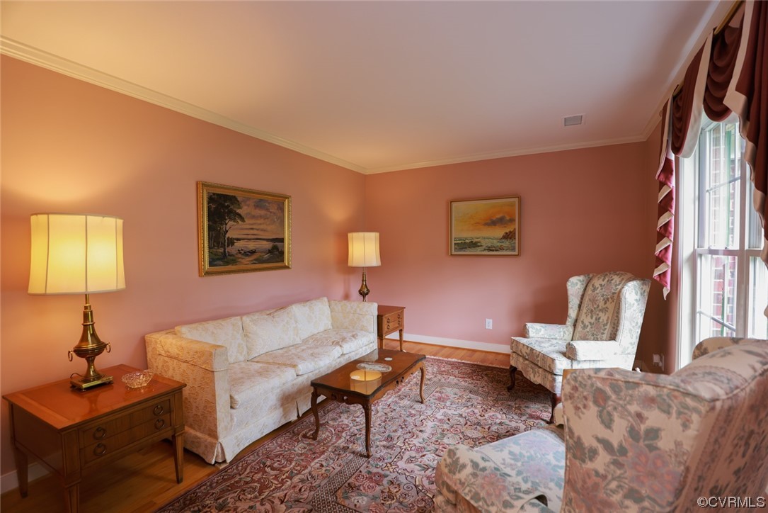 12610 Lilking Road Chester, VA 23831 - Photo 10 of 50 a living room with furniture a lamp paintings and a window