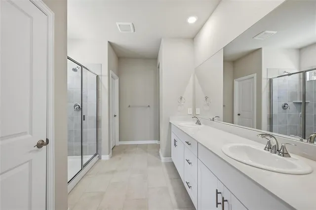 a spacious bathroom with a double vanity sink mirror and double