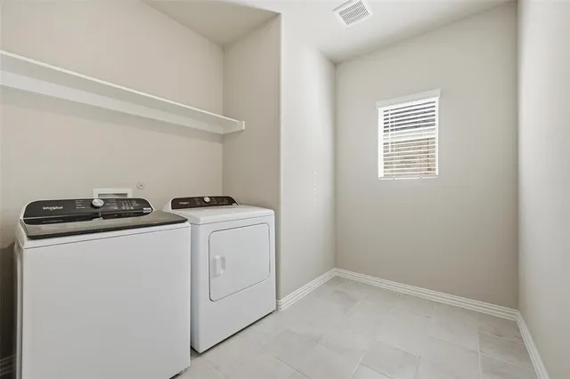a view of storage and utility room with washer and dryer