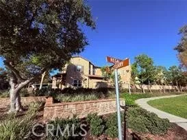a front view of a house with trees around
