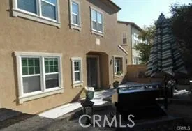 a backyard of a house with table and chairs