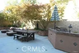a backyard of a house with yard fountain and outdoor seating