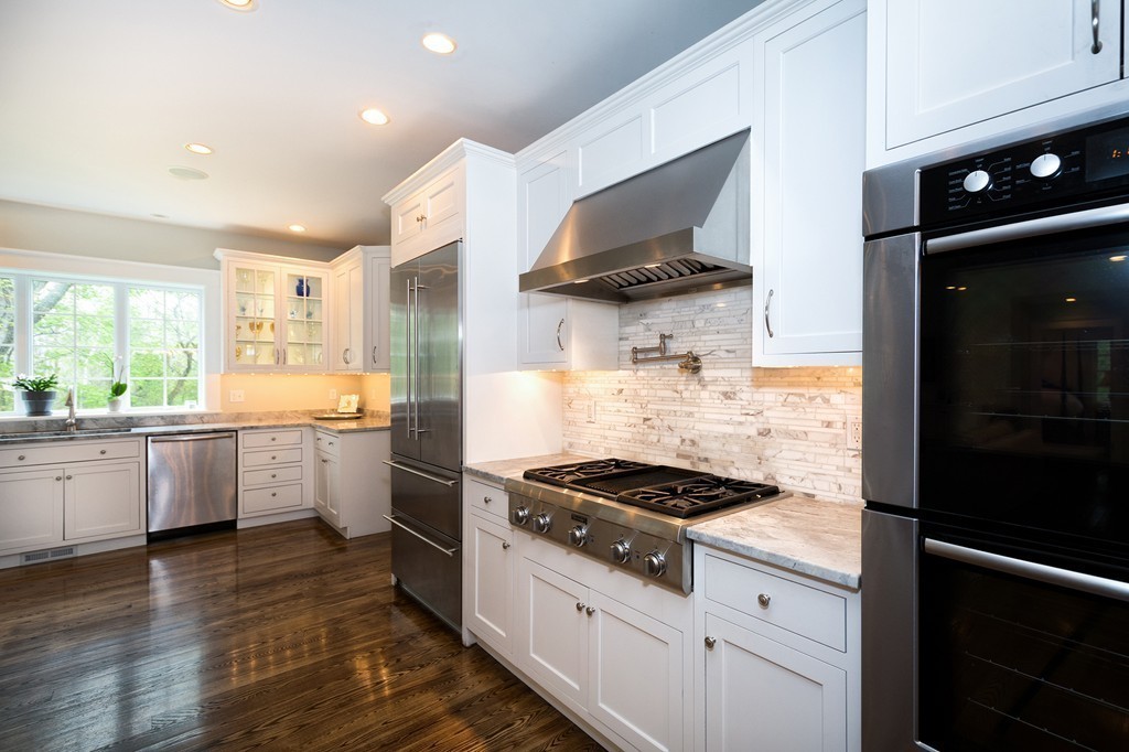 158 First Parish Road Scituate, MA 02066 - Photo 11 of 27 a kitchen with stainless steel appliances kitchen island granite countertop a stove a sink and a microwave