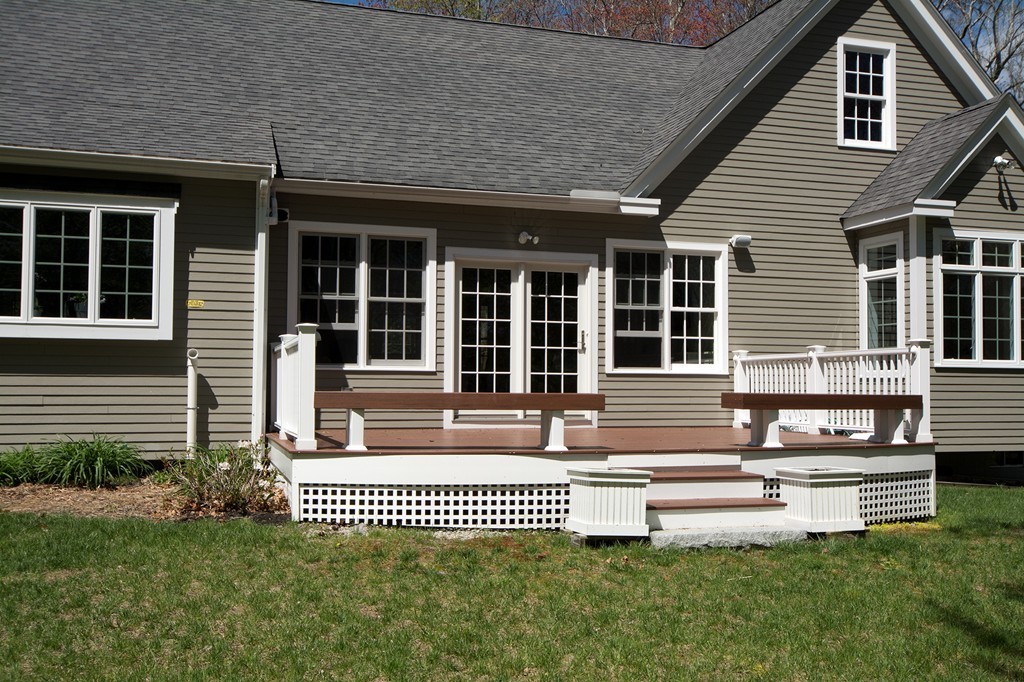 158 First Parish Road Scituate, MA 02066 - Photo 25 of 27 a front view of a house with a garden and deck