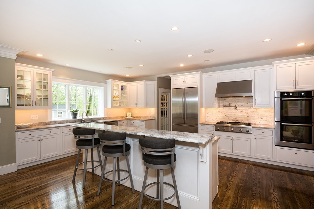 158 First Parish Road Scituate, MA 02066 - Photo 7 of 27 a kitchen with stainless steel appliances a stove a sink a microwave a refrigerator and chairs
