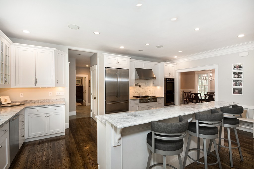 158 First Parish Road Scituate, MA 02066 - Photo 8 of 27 a kitchen with stainless steel appliances kitchen island granite countertop a sink and cabinets