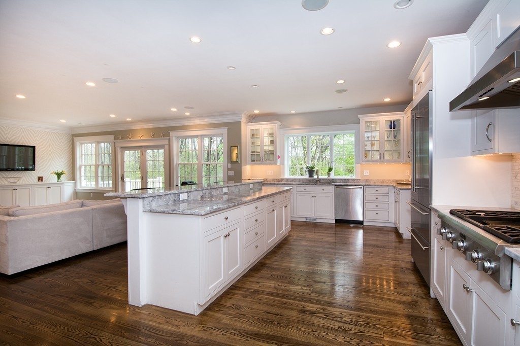 158 First Parish Road Scituate, MA 02066 - Photo 10 of 27 a large kitchen with stainless steel appliances kitchen island granite countertop a large counter top and a stove