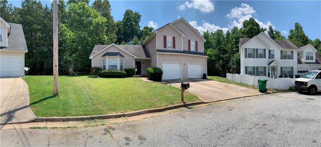 2343 Creekview Trail Decatur, GA 30035 - Photo 1 of 1 a view of a white house with a yard plants and large tree