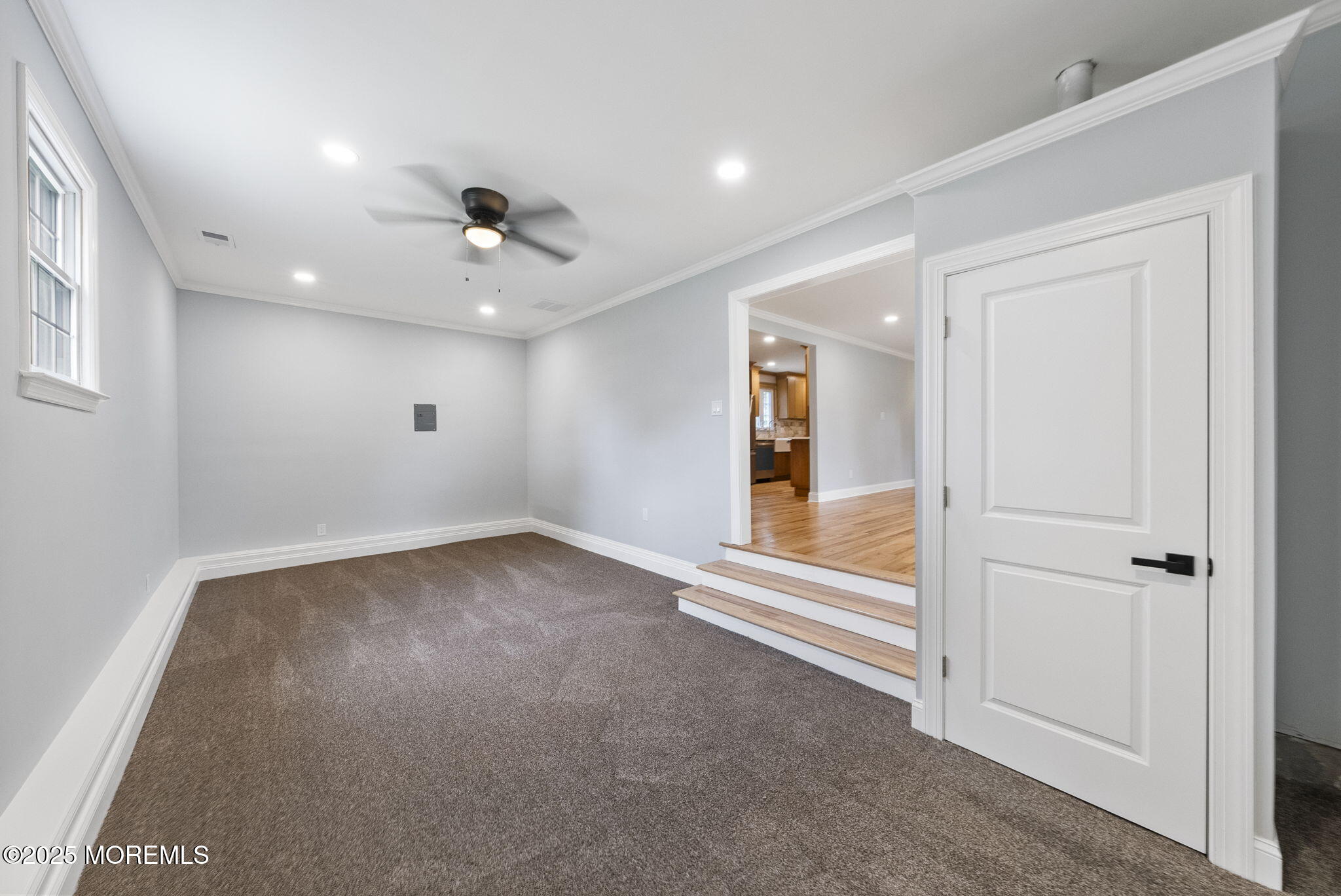 34 Traymore Road Freehold, NJ 07728 - Photo 7 of 23 an empty room with a ceiling fan and windows