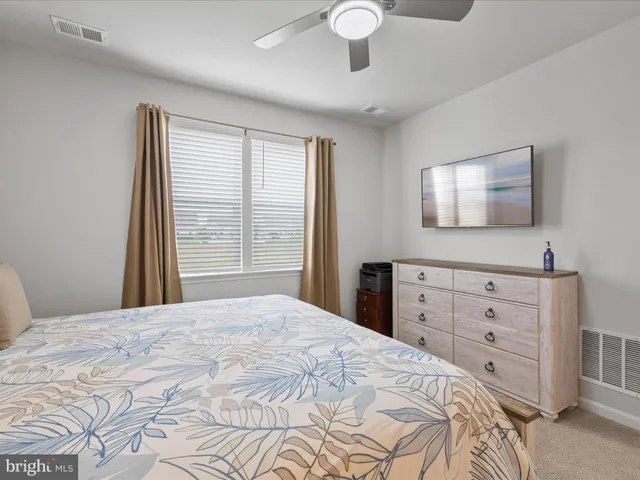 a bedroom with a large bed and a night stand