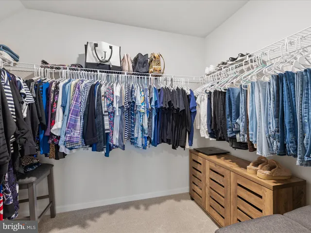 a en suite bathroom with 2 sink bed and a window