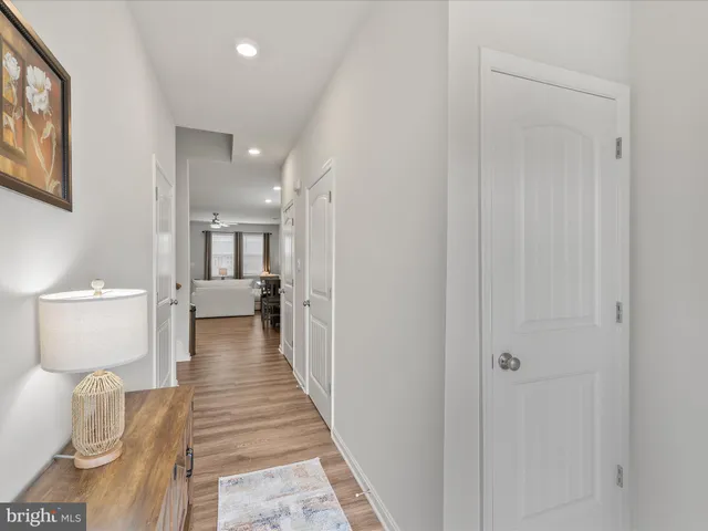 a view of a bedroom with wooden floor and furniture