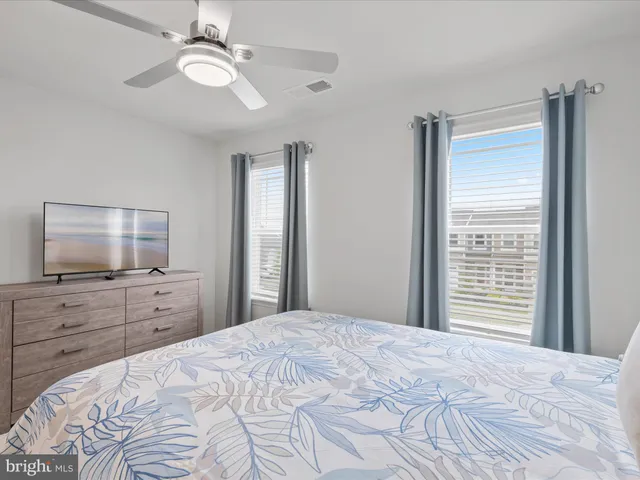 a bedroom with a bed and painting on the wall