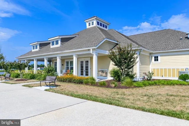 an aerial view of a house with outdoor space and lake view in back