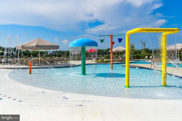a view of a swimming pool with lawn chairs