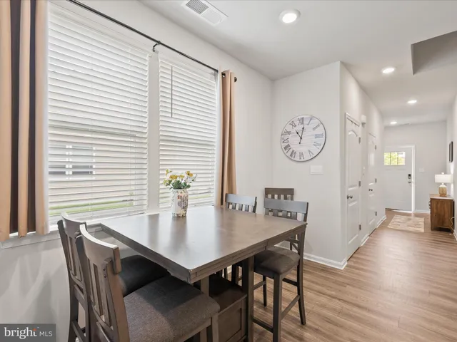 a view of a dining area with furniture and wooden floor