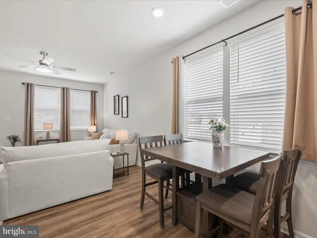a open kitchen with granite countertop white cabinets and stainless steel appliances