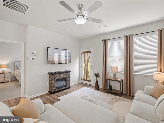 a living room with furniture and kitchen view