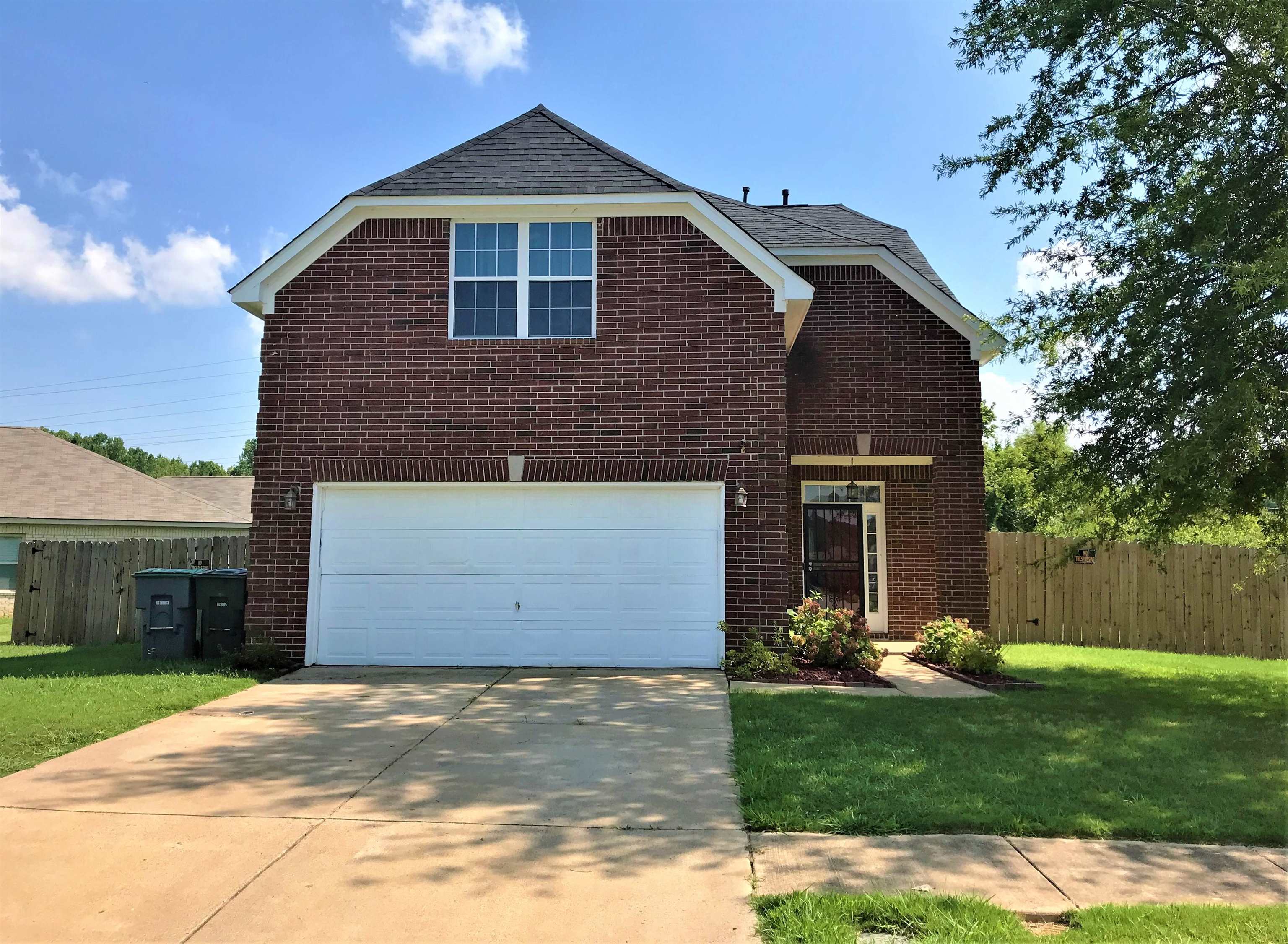 871 Ruby Creek Cove Memphis, TN 38109 - Photo 1 of 16 a front view of a house with a yard and garage