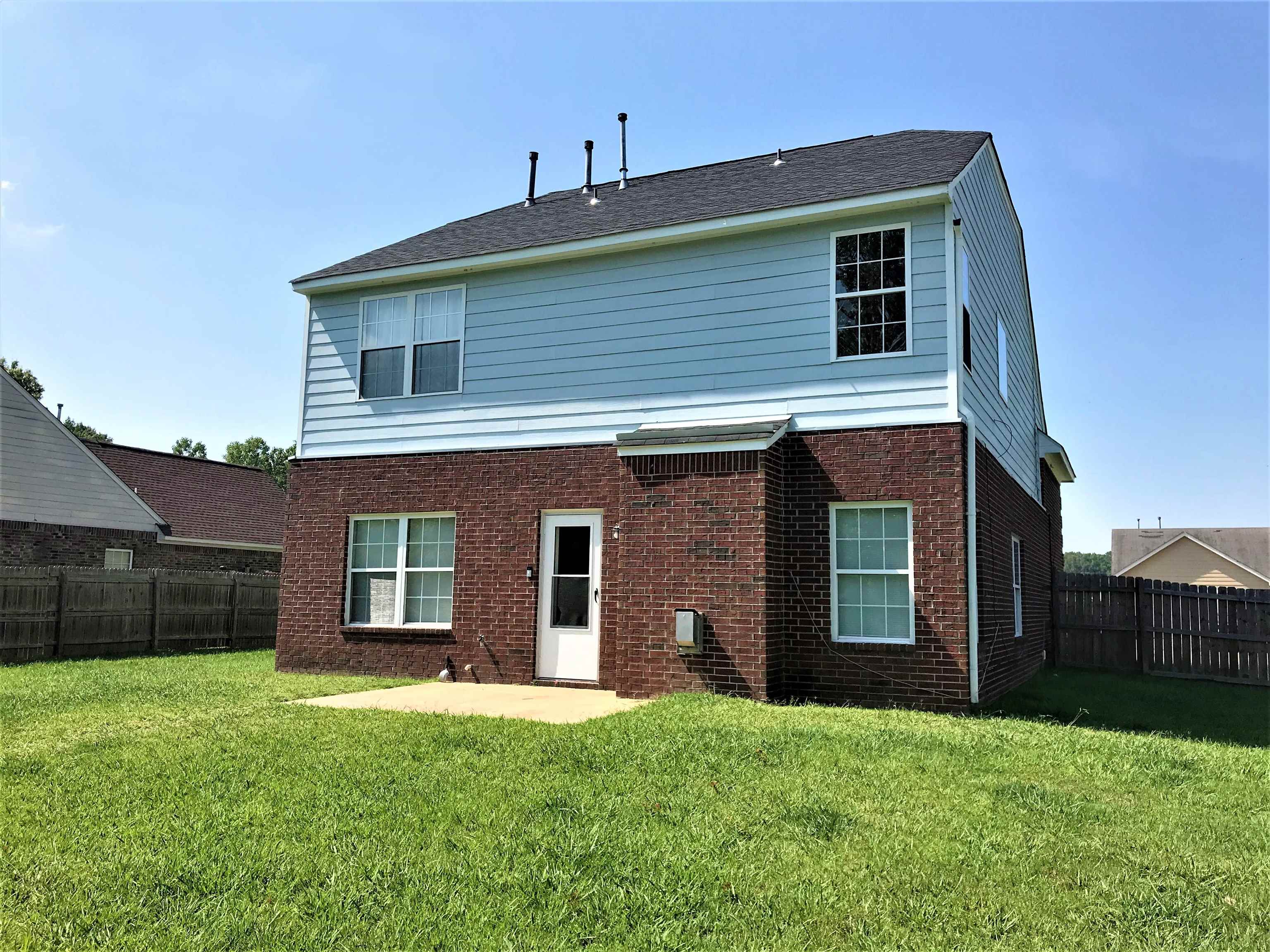 871 Ruby Creek Cove Memphis, TN 38109 - Photo 16 of 16 a front view of a house with a yard and garage