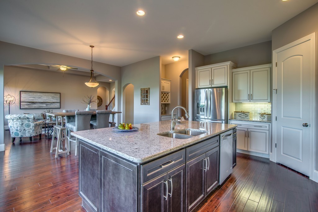 1026 October Park Way Franklin, TN 37067 - Photo 14 of 27 a kitchen with center island table and chairs
