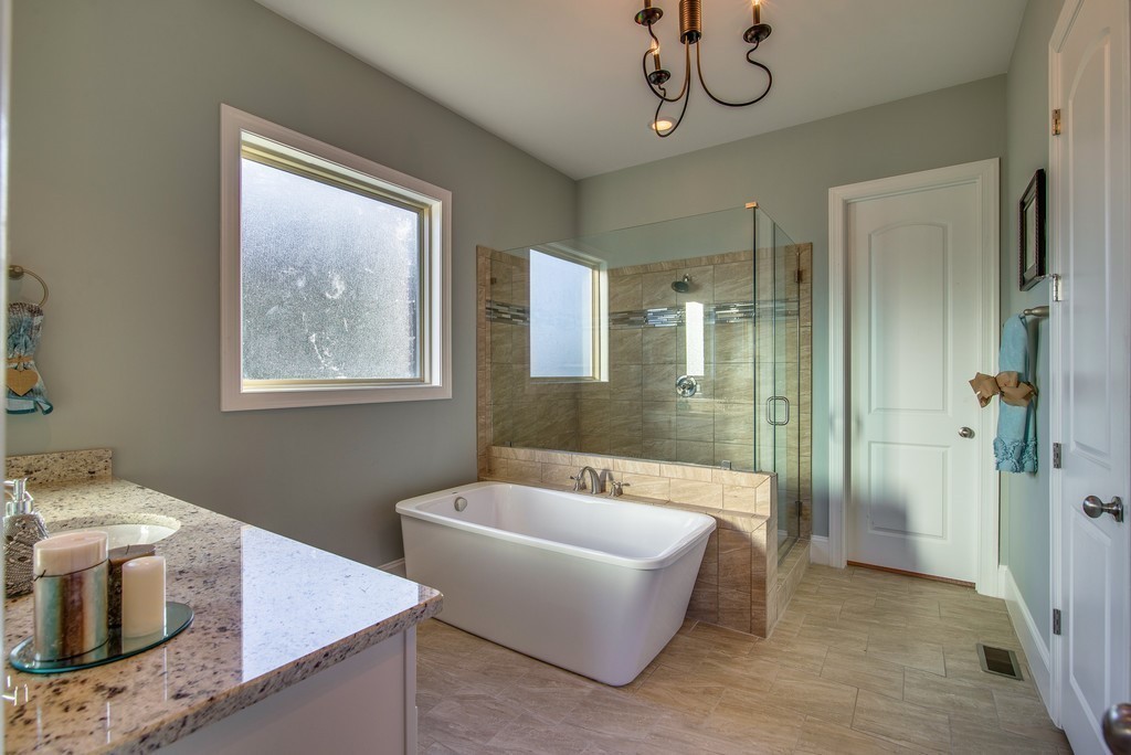 1026 October Park Way Franklin, TN 37067 - Photo 17 of 27 a spacious bathroom with a tub sink and mirror