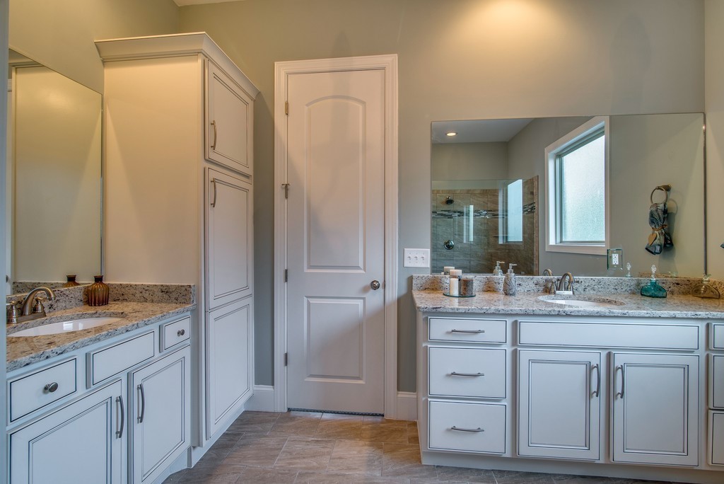 1026 October Park Way Franklin, TN 37067 - Photo 18 of 27 a spacious bathroom with a granite countertop sink and a mirror