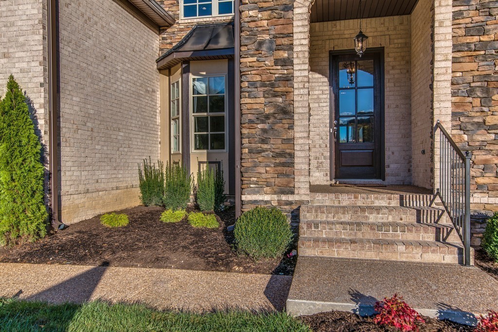 1026 October Park Way Franklin, TN 37067 - Photo 3 of 27 a front view of a house with a yard