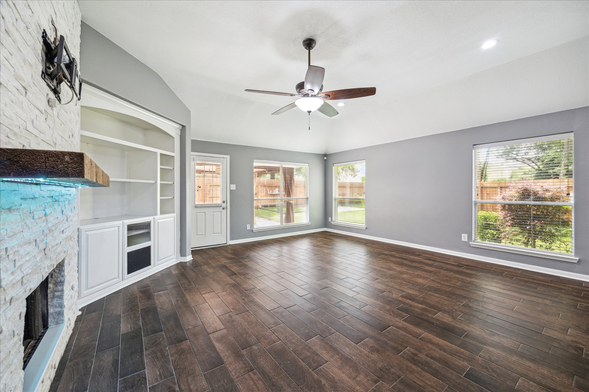 20910 Sandy Briar Court Spring, TX 77379 - Photo 9 of 28 a view of an empty room with wooden floor and a window