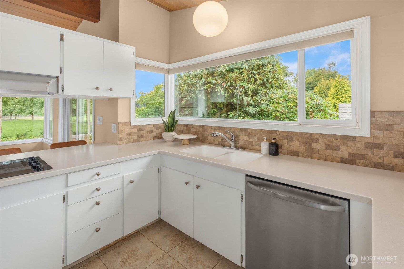 618 Riverview Drive Monroe, WA 98272 - Photo 14 of 39 a kitchen with white cabinets and a large window