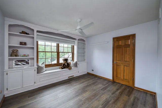 a view of a livingroom with wooden floor and a window
