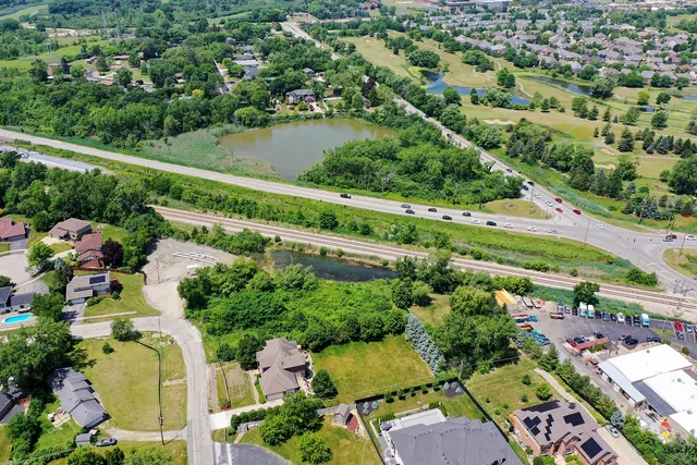an aerial view of a residential houses with outdoor space and street view