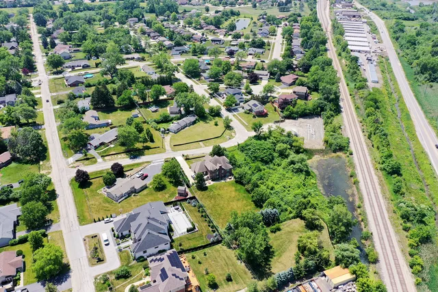 an aerial view of a city with lots of residential buildings and mountain view in back