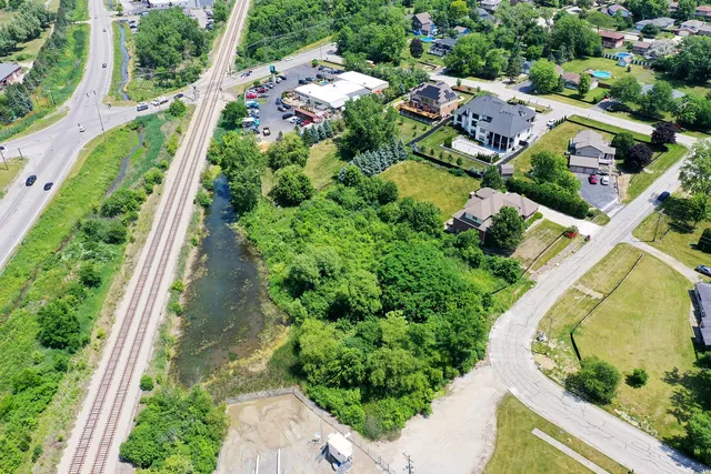 an aerial view of a house with a garden and swimming pool