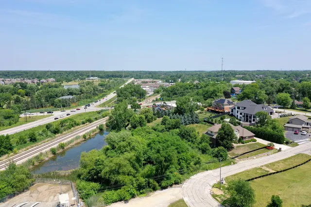 an aerial view of residential houses with outdoor space and street view