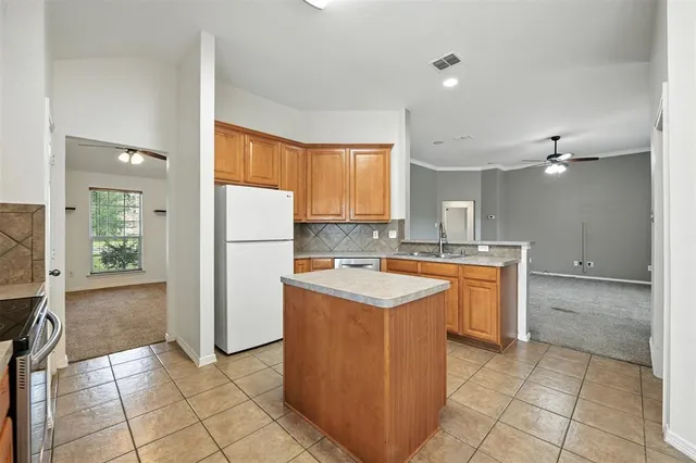 a kitchen with a sink a counter top space and cabinets