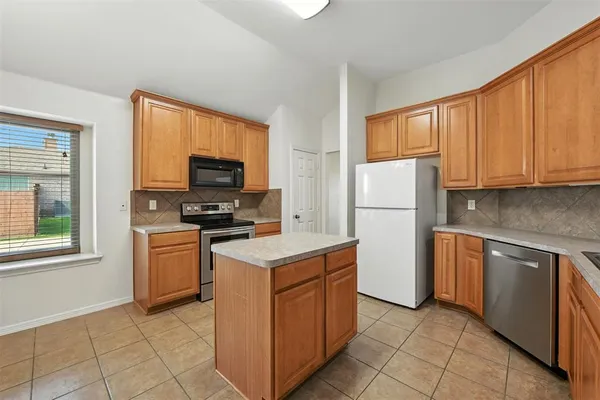 a kitchen with a refrigerator stove and microwave