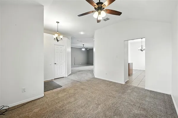 wooden floor in an empty room and a chandelier fan