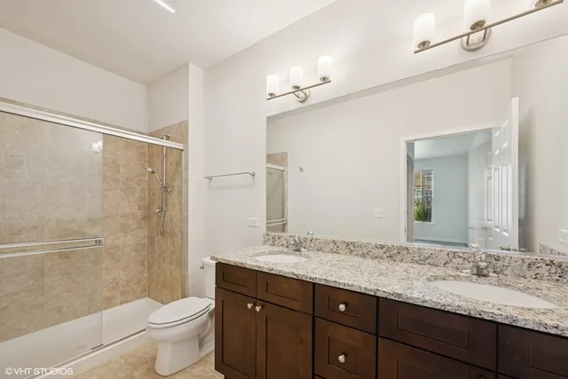 a bathroom with a granite countertop sink toilet and shower