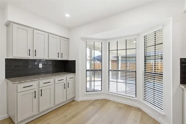 a kitchen with stainless steel appliances granite countertop a sink a microwave and cabinets