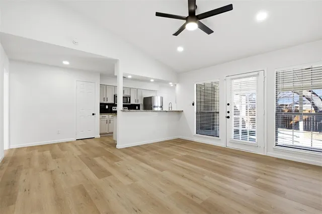 a view of a kitchen with a sink and cabinets